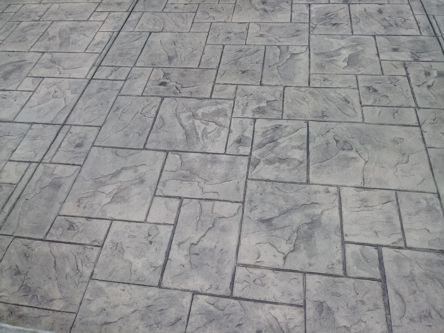 Hardscaping contractor Fort Mill, SC Stamped concrete patio installation by skilled Hardscaping contractor Fort Mill, SC, featuring ashlar slate pattern